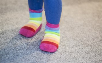 Colourful socks on the feet of a three-year-old child