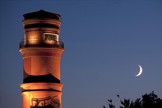The old lighthouse in the port of Travemuende at night