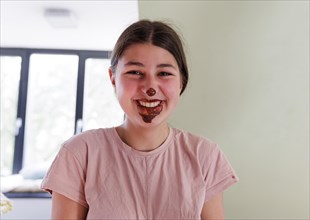 Girl with a chocolate-smeared mouth