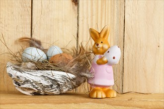 Easter Nest with Easter Bunny on the Wooden Background