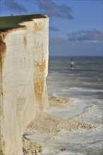 View over the eroded white chalk cliffs and lighthouse at Beachy Head