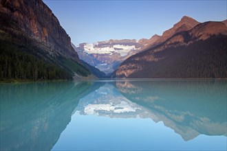 Glacial Lake Louise with Victoria glacier and mountains reflected in emerald water