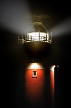 Light beams from lantern of the Cocksdorp lighthouse Eierland at night