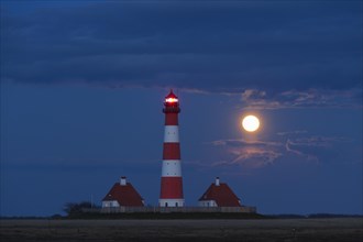 Lighthouse Westerheversand at night with full moon at Westerhever
