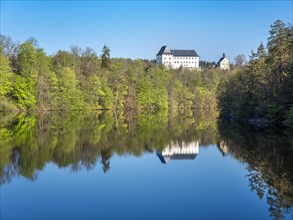 Burgk Castle reflected in the Burhkhammer Dam on the River Saale in spring