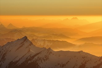 Golden sunset in winter with view from Saentis to Pilatus in Central Switzerland