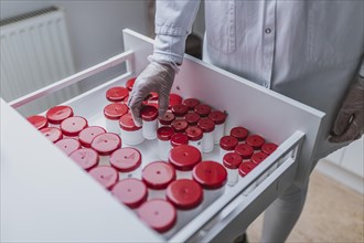 A prescription worker takes a TopTec Kruke from a drawer