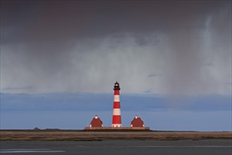 Downpour over the lighthouse Westerheversand at Westerhever
