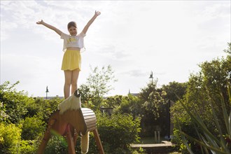 Girl gymnastics on a wooden horse