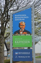 Sign and poster with Friedrich Wilhelm Raiffeisen founder of the society and cooperative bank