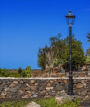 Lantern in front of a stone wall