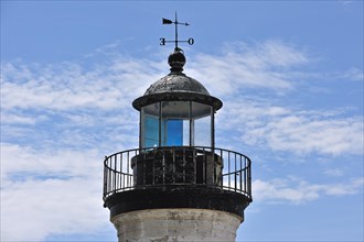 Detail of top of old abandoned lighthouse in the harbour of Guilvinec