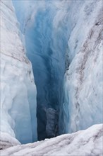 Crevasse in ice sheet of glacier caused by glacial meltwater