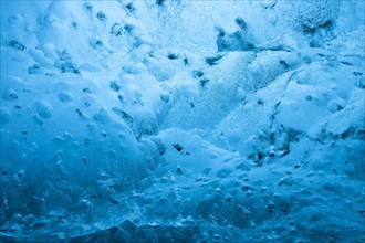 Blue ice mixed with volcanic ash in ice cavern inside Breidamerkurjokull