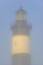 The lighthouse phare de Chassiron in the mist at Saint-Denis-dOleron on the island Ile dOleron