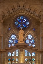 Statue of the saint and stained glass window