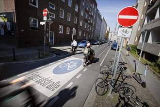 Symbolic photo on the subject of bicycle lanes in the city. Cyclists ride on the bicycle street in Linienstrasse in Berlin Mitte. Berlin