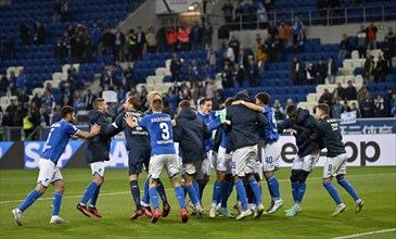TSG 1899 Hoffenheim players dance and celebrate their victory in front of the fan curve