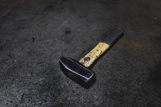 A hammer lying on a workbench