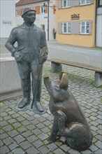 Sculptures at the Piggy Fountain with Pig Figure and Man