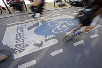 Symbolic photo on the subject of bicycle lanes in the city. Cyclists ride on the bicycle street in Linienstrasse in Berlin Mitte. Berlin
