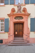 Entrance with patron saint St. Urban figure to the baroque St. Andreas Hospital
