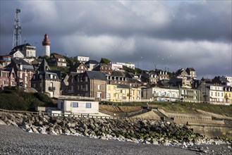 View over the houses and lighthouse of the village Ault seen from the beach