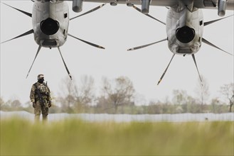 A Bundeswehr soldier stands in front of the Airbus A400M aircraft