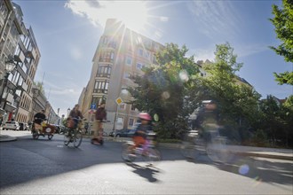 Symbolic photo on the subject of cycling in the city. Cyclists ride on the bicycle lane in Linienstrasse in Berlin Mitte. Berlin