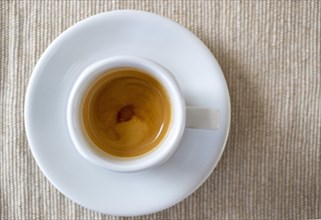 A cup filled with delicious espresso from above