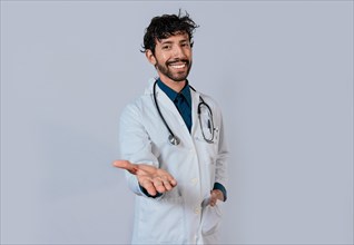 Smiling doctor extending hand in welcome. Young doctor extending hand to camera