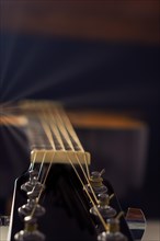 Spanish classical guitar with sun reflections on a black background