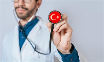 Doctor holding stethoscope with Turkey flag. Turkey Health and Care Concept