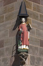 Coloured sculpture of Saint Laurence on a residential house