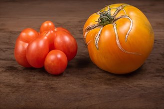 Antique-type tomatoes placed on wooden kitchen table. France