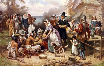 The first harvest festival in 1621. Pilgrims and natives gather to eat together