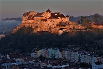 The castle in Burghausen in the first morning light above the historic old town