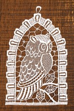 Crocheted owl on wooden background