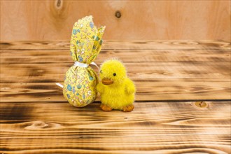 Chick made of fabric next to Easter egg made of fabric