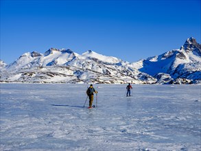 Ski mountaineers cross the frozen Kong Oscar Fjord