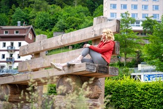 Woman sitting on huge bench in spa gardens