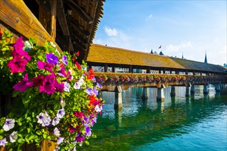 Chapel Bridge With Flowers in City of Lucerne and Reuss River in Switzerland