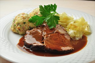 Roast beef with bread dumplings and white cabbage