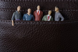 Tiny figurine of group of men miniature model in pockets