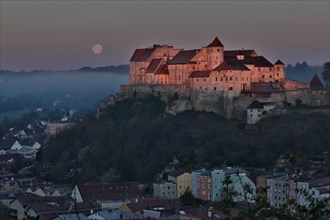 The castle in Burghausen in the first light of the morning above the historic old town