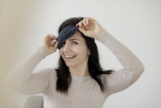 Happy woman with eye mask