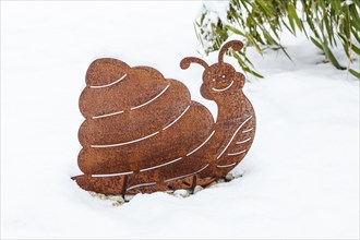 Snail made of tin in winter