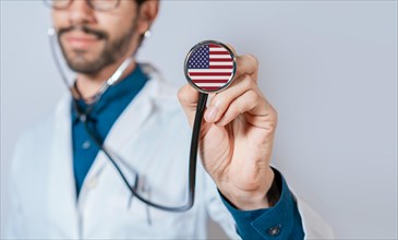 USA flag on stethoscope. Doctor holding stethoscope with USA flag