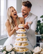 A young wedding couple at the wedding reception has fun