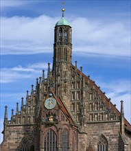 Tower of the historic Church of Our Lady with clock and the Maennleinlaufen